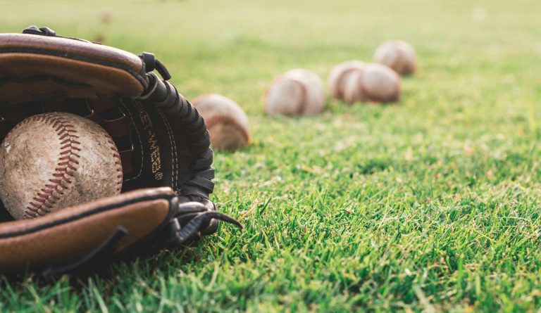 baseball-glove-with-baseball-on-field